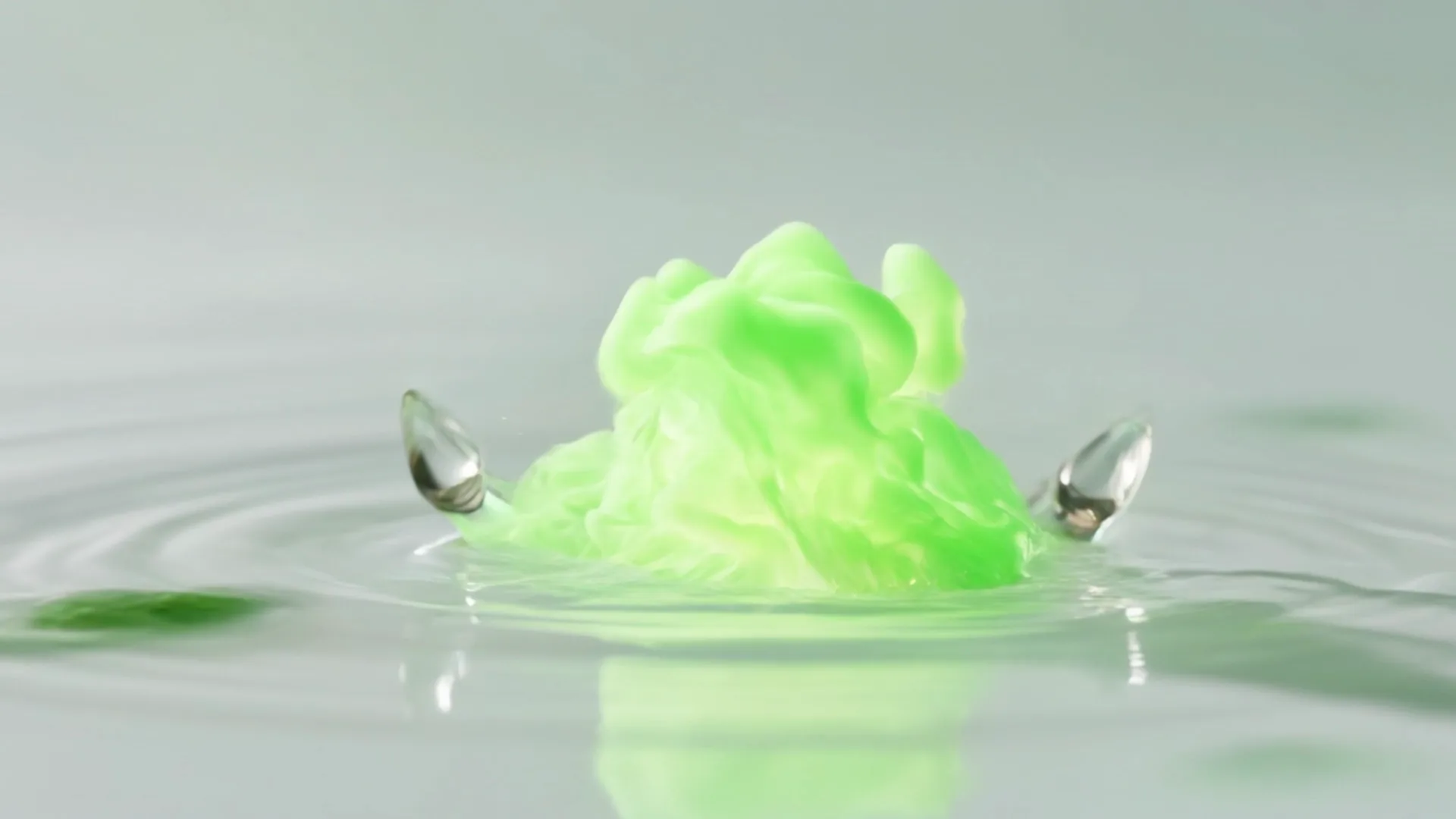 Macro view of a crystal water droplet in bright sunlit space, splitting into glowing streams that bloom into luminous green energy.